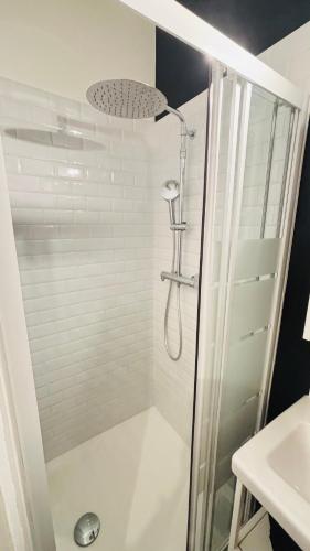 a shower with a glass door in a bathroom at La Demeure des Troubadours - Hyper centre in Provins