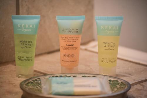 a group of four bottles of sunscreen on a table at Yonegan Maui Getaways - Haiku in Haiku