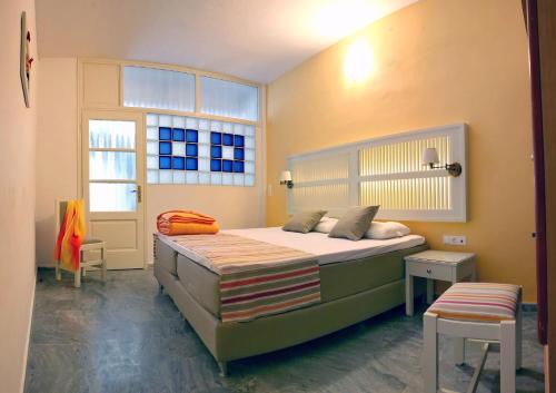 a bedroom with a large bed and a window at Sunset Hotel in Petra