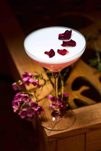 a martini glass with red roses on top of a table at Kryve Ozero in Novoyavorivsk