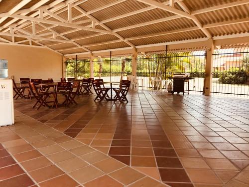 a patio with tables and chairs in a building at One Bedroom House Punta Chame Club and Resort in Pajonal