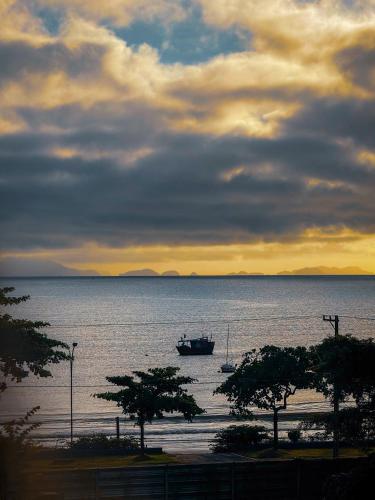a boat in the middle of a large body of water at Hotel Parque Atlântico in Ubatuba
