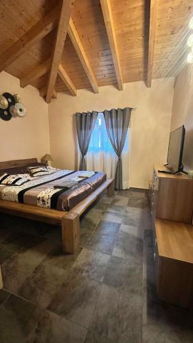 a bedroom with a bed and a television in a room at BeauLieu in Fully