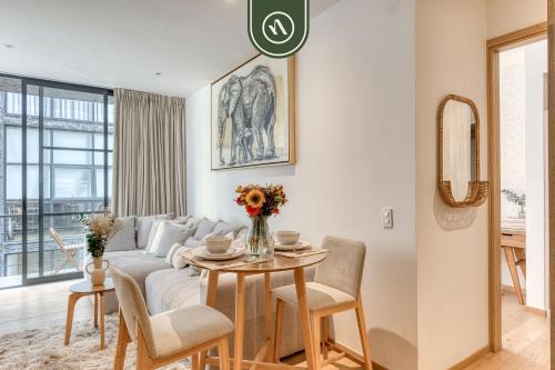 a living room with a couch and a table at Centric 2 BR Condo - Gym - Open Air Cinema in Mexico City