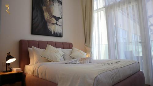 a bedroom with a large bed with a window at Terminal 1BR Retreat - Modern Comfort & Chic Stay in Abu Dhabi