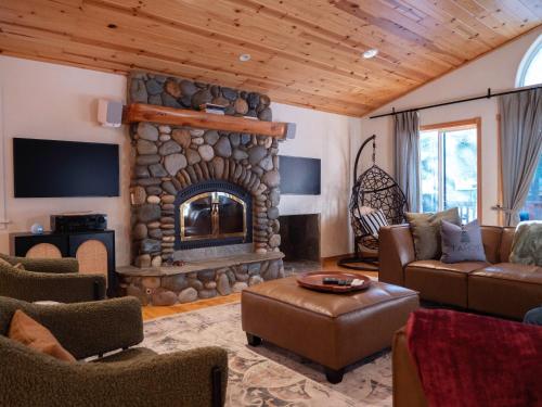 a living room with a stone fireplace and a couch at Mountain Retreat near Skiing, HotTub, PetFriendly in Tahoe City