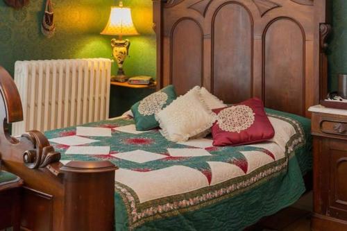 a bedroom with a bed with pillows on it at Fitzroy Hall in Charlottetown