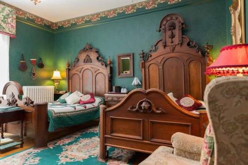 a large bedroom with two beds and green walls at Fitzroy Hall in Charlottetown