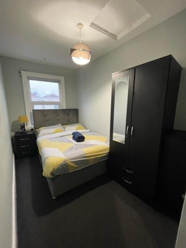 a bedroom with a bed and a window and a mirror at The Old White Hart Brewery Guesthouse in Bath