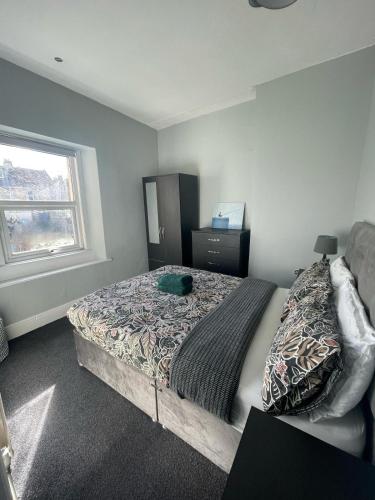 a bedroom with a large bed and a window at The Old White Hart Brewery Guesthouse in Bath