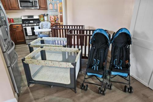 a couple of strollers sitting next to a kitchen at Carnival Dream - Arcades, Carousel, Playground and more! in Orange