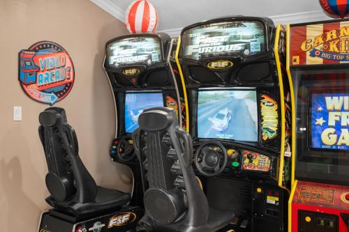 two arcade machines with video games in a room at Carnival Dream - Arcades, Carousel, Playground and more! in Orange