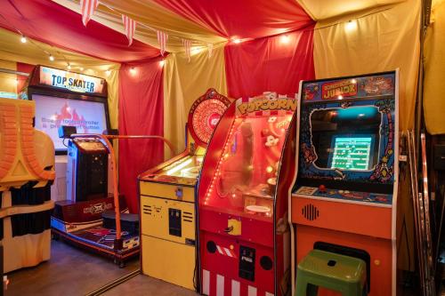 a arcade game in a room with a video game at Carnival Dream - Arcades, Carousel, Playground and more! in Orange