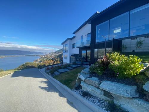 a building with a view of the water at Luckie Lane Homestay in Queenstown