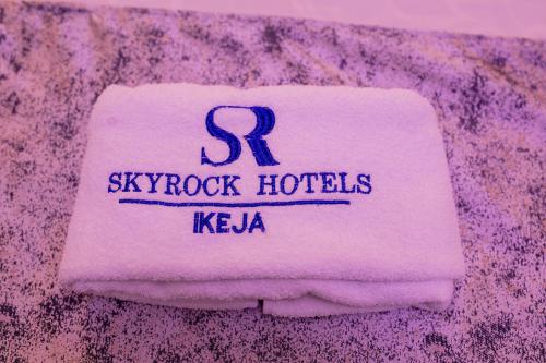 a towel with the name of skyprocket hotels on it at Skyrock Hotels Ikeja in Ikeja