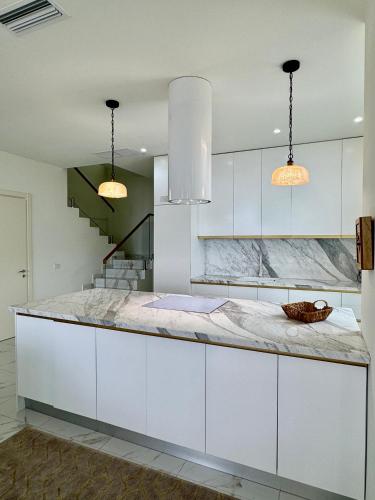 a kitchen with white cabinets and a counter top at Crystal Pool Villa, Green Coast, Palase in Palasë