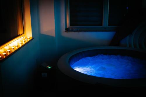 a blue bath tub in a room with a window at Stan na dan Kvadar in Brčko