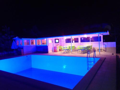 a swimming pool at night with blue lights at Karaca Apart Hotel in Dalyan
