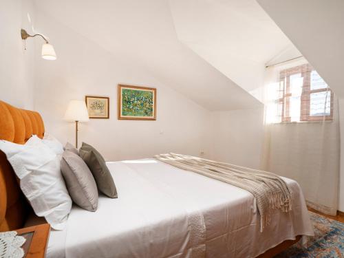 a white bedroom with a white bed and a window at Lavanda Mansion in Vodice