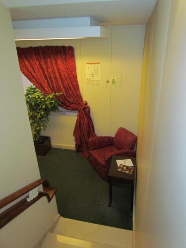 a room with a red chair and a window at Vera Cruz Porto Downtown Hotel in Porto