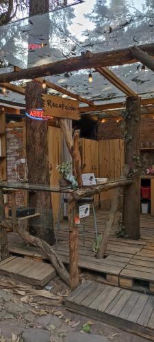 a wooden cabin with a table with a sign on it at Mindfulness Glamping, Retiro de Yoga, Todo Incluido in Mexico City