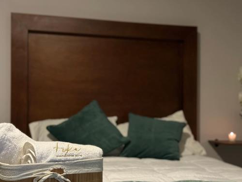a pair of shoes sitting on top of a bed at FIKA Apartamentos Elite in Toluca