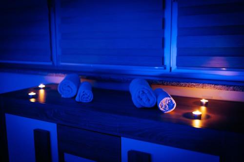 a counter with candles and clocks on it with lights at Stan na dan Kvadar in Brčko
