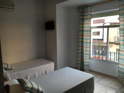 Cama o camas de una habitación en Hostal Barbate