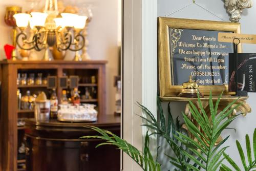 a restaurant with a menu on a chalkboard next to a bar at Mama’s Inn Boutique Guest House in Nottingham