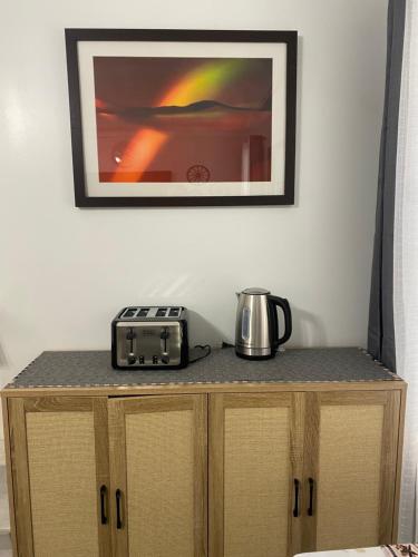 a table with a toaster and a coffee maker on it at La Casa De Francella in Houston