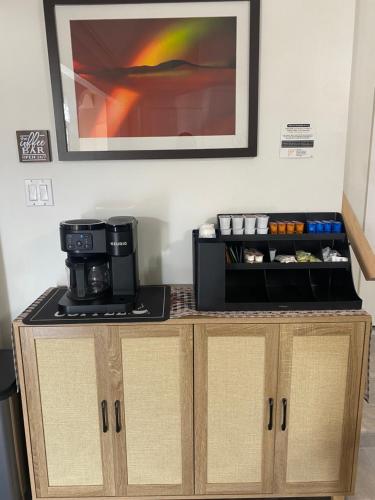 a counter with a coffee maker and a microwave at La Casa De Francella in Houston