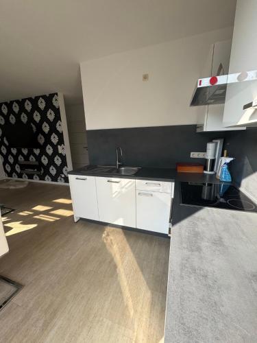 a kitchen with a sink and a white cabinet at Wohnung mit Garten und Whirlpool in Berlin