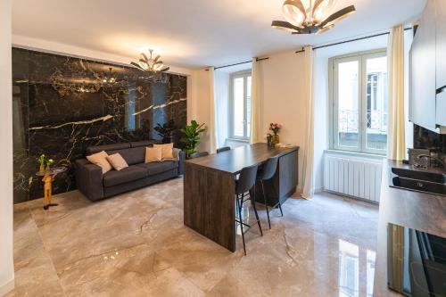 a kitchen and living room with a table and a couch at Magic Place Bergamo! Classy Apartment in the heart of the city in Bergamo