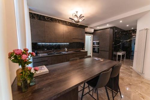 a kitchen with a large wooden table and chairs at Magic Place Bergamo! Classy Apartment in the heart of the city in Bergamo