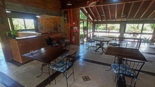 um restaurante com mesas e cadeiras em uma sala em Pousada Aurora da Mantiqueira Penedo em Penedo