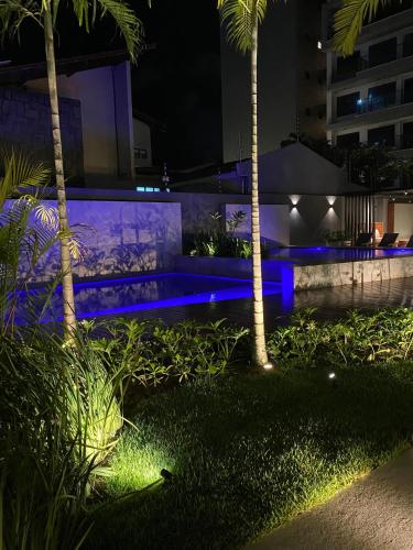 a night view of a pool with blue lighting at Vert House in João Pessoa