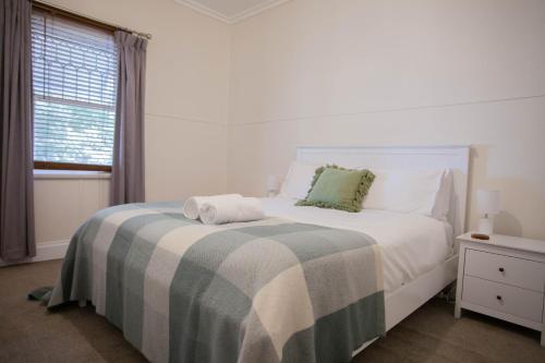 una camera da letto bianca con un letto e una finestra di Cosy Cottage 2br Ballarat Stay Close To Cbd a Ballarat