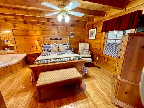 a bedroom with a bed and a tub and a ceiling fan at Bearfoot in Townsend
