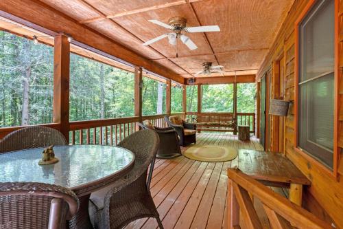 a screened in porch with a table and chairs at Whiskey in the Woods in Townsend