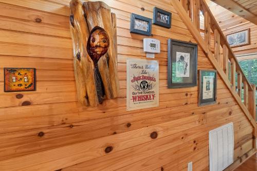 a wall of a log cabin with posters on it at Whiskey in the Woods in Townsend