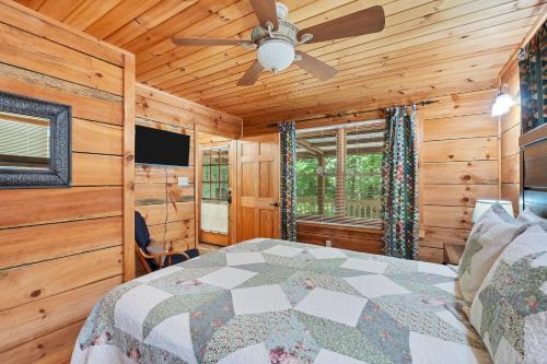 a bedroom with a bed and a ceiling fan at Whiskey in the Woods in Townsend