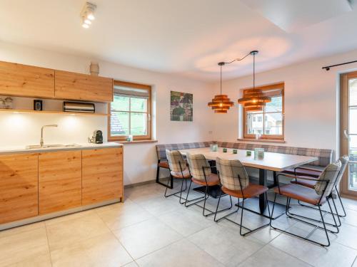 a kitchen with a table and chairs in it at Haus Enzian in Donnersbachwald