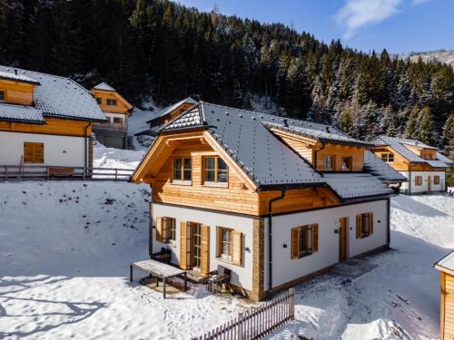 a log home in the snow with trees at Haus Enzian in Donnersbachwald