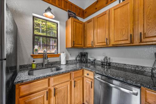 a kitchen with wooden cabinets and a sink and a window at Golden Valley Retreat in Townsend