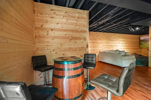 a wine tasting room with a barrel and chairs at Golden Valley Retreat in Townsend