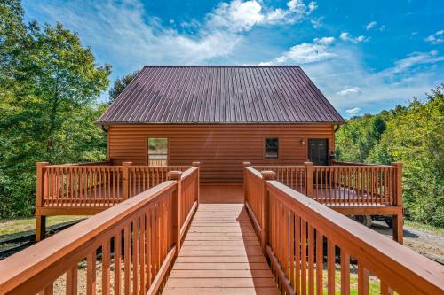 a cabin with a wooden deck and a roof at Golden Valley Retreat in Townsend