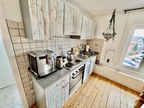 a kitchen with a sink and a microwave at Riverside Retreat with Comfort in Geesthacht