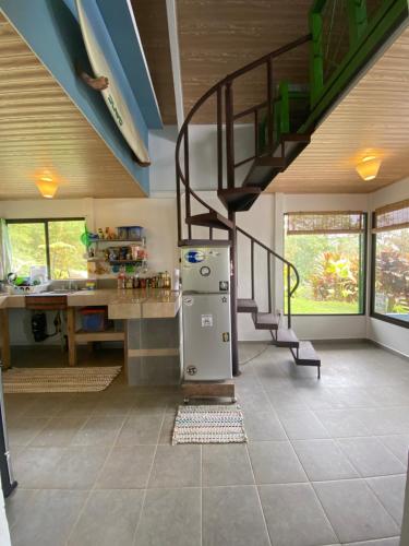 a kitchen with a spiral staircase and a refrigerator at Casa Veronica in Italcancori