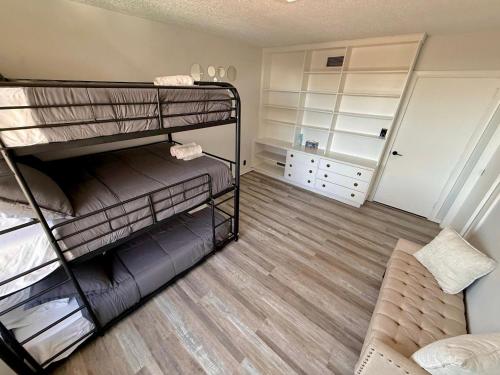a room with two bunk beds in a room at Ultimate Luxury Villa - Pool, Sauna, Hot Tub & More in Paterson
