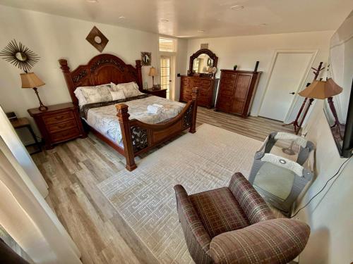 a bedroom with a bed and a chair and a couch at Ultimate Luxury Villa - Pool, Sauna, Hot Tub & More in Paterson